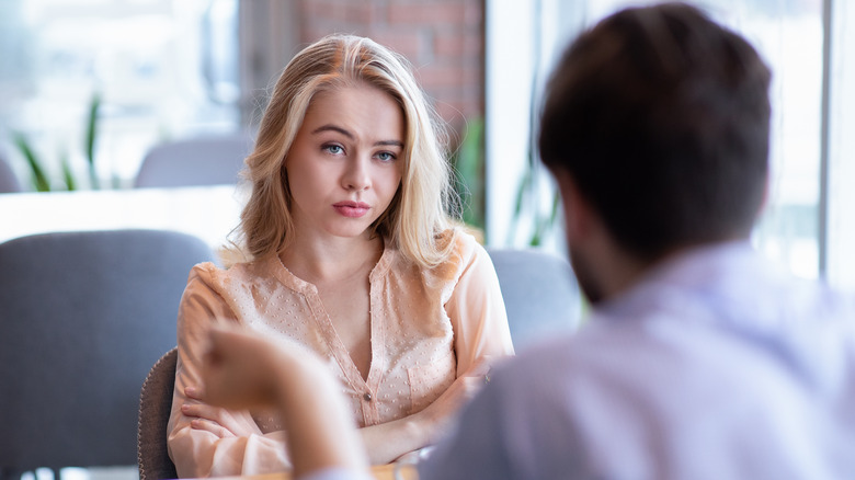 Annoyed woman looking at man