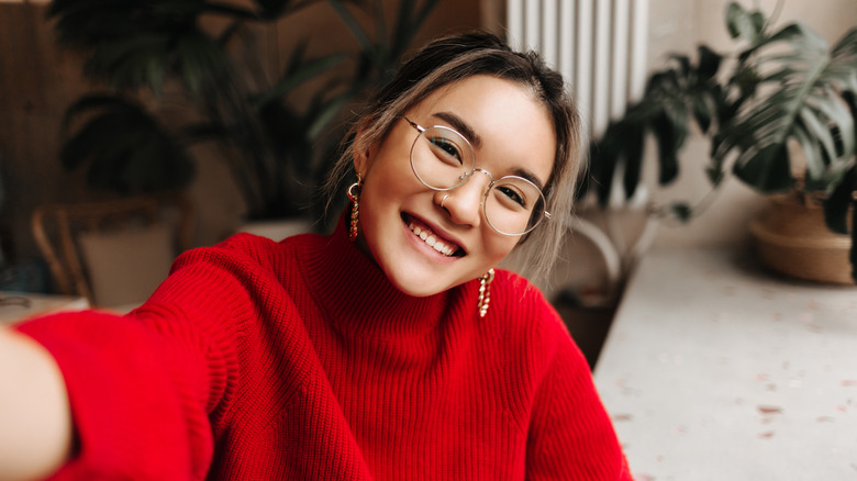 woman with light eye makeup and glasses