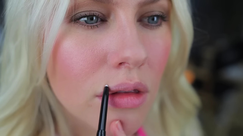 woman using clear lip liner