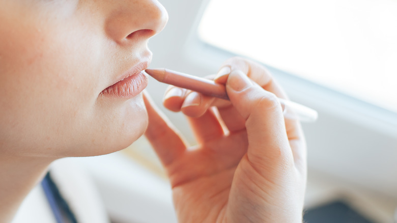 woman applying lip stick