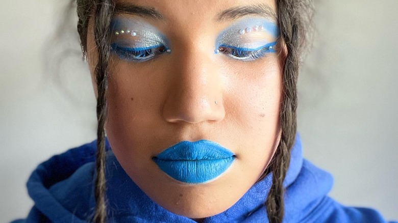 Blue makeup with face gems