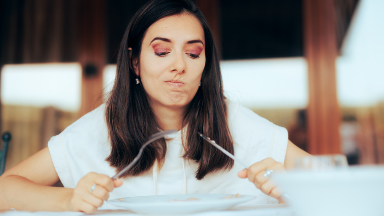 woman disgusted plate of food