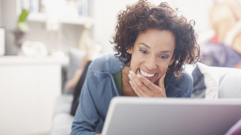 woman smile look at laptop