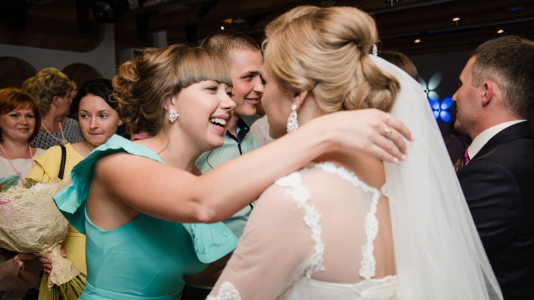 woman talking to bride