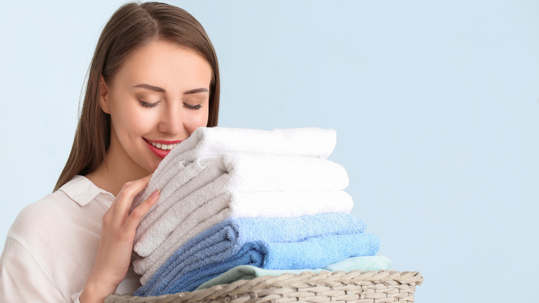 Woman smelling clean towels