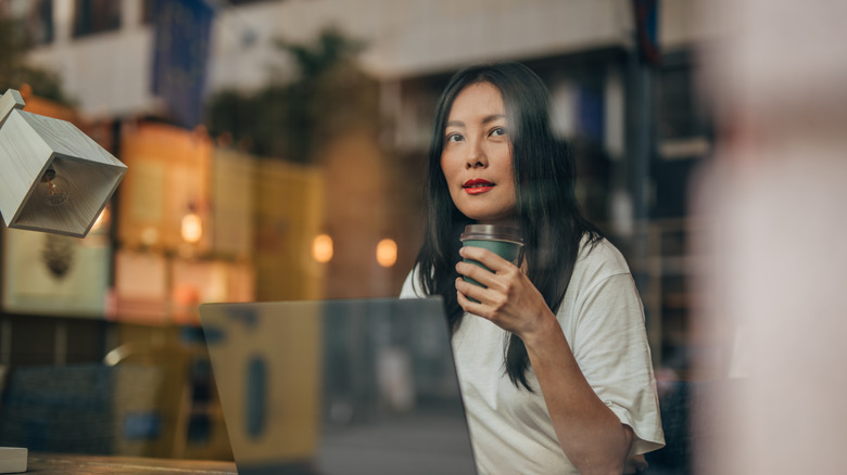 Woman thinking in front of computer