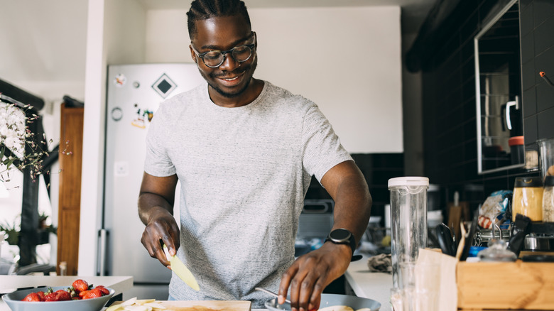 Man smiling and cooking