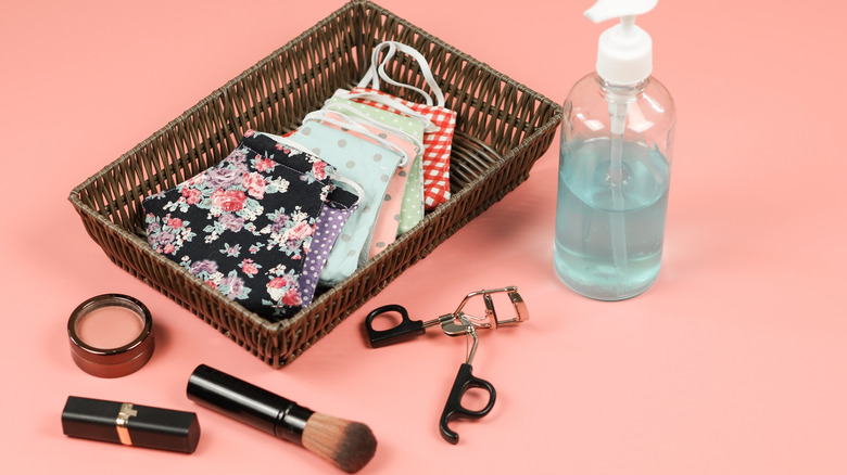 soap with a tray of masks and makeup