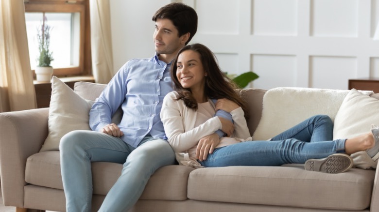 Couple cuddling on the couch