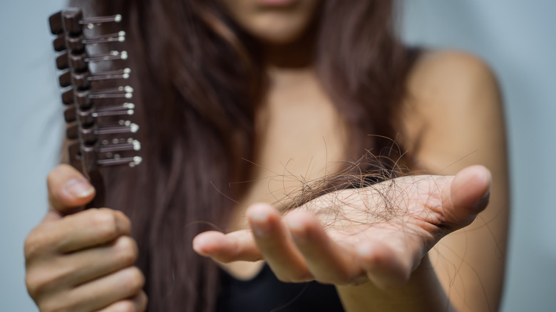 closeup of woman's hand with hair in it