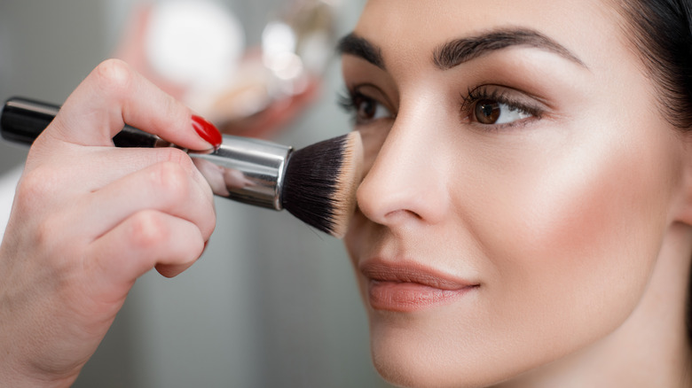 woman having makeup done