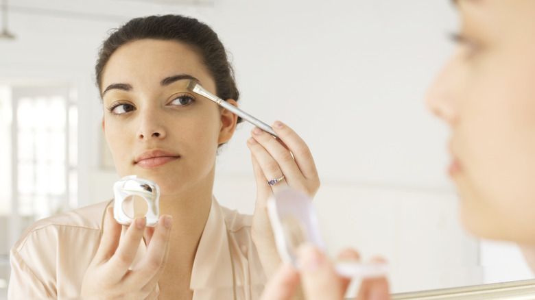 woman applying eyeshadow