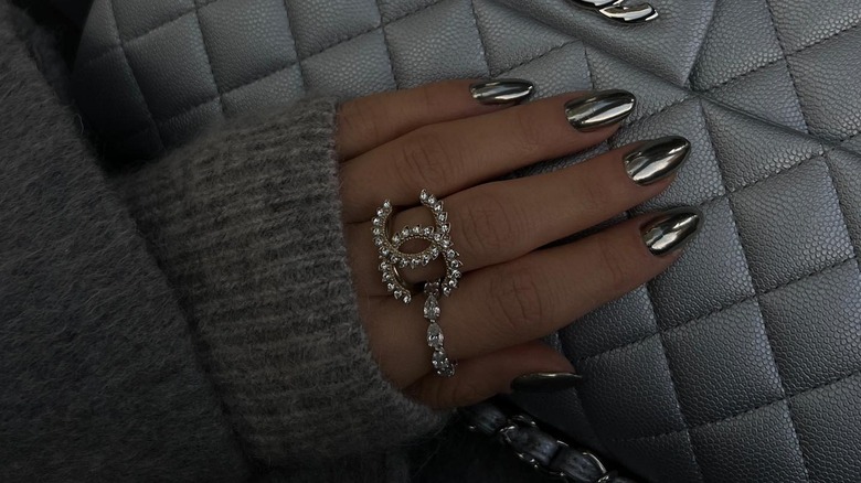 woman's hand with silver metallic nails