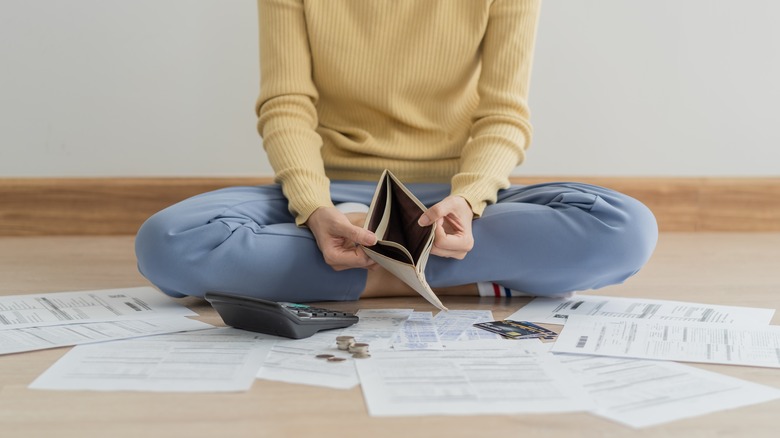 Woman surrounded with bills