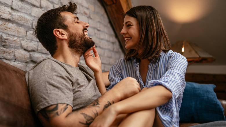 Woman touching partner's beard