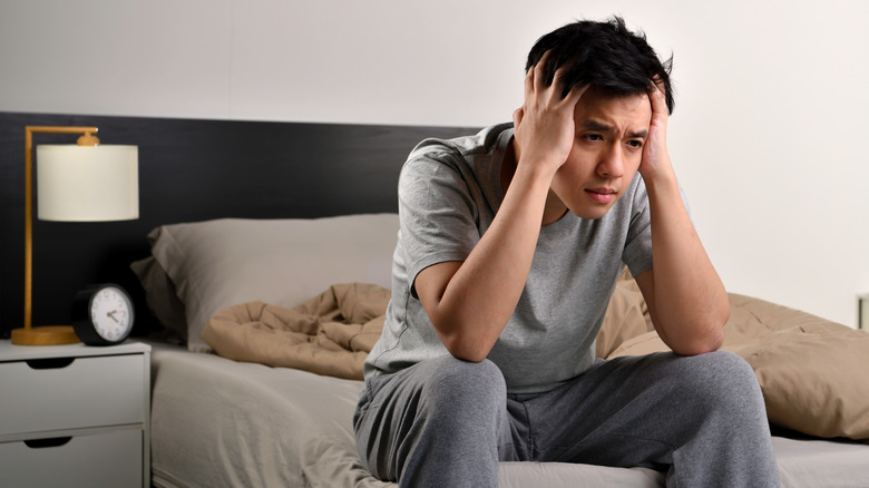 Man sitting on bed awake