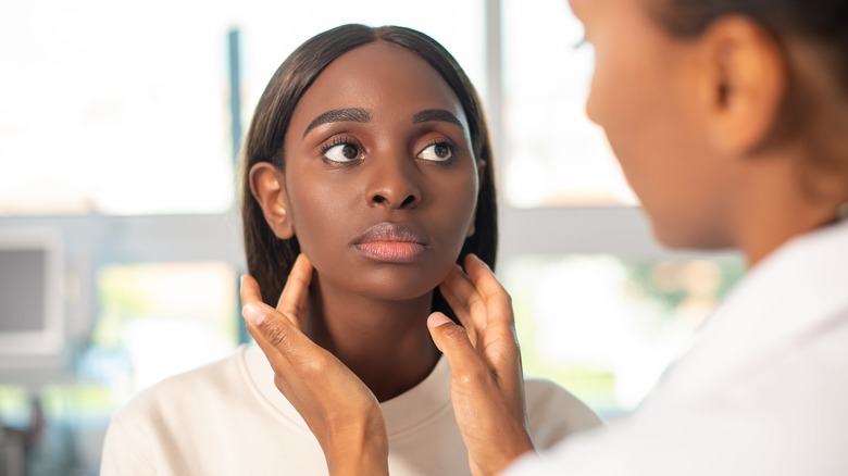 Female patient being assessed by endocrinologist