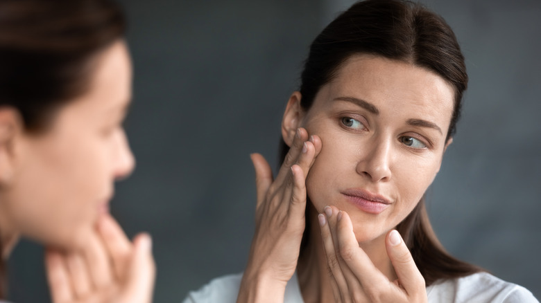 Woman running hands over face