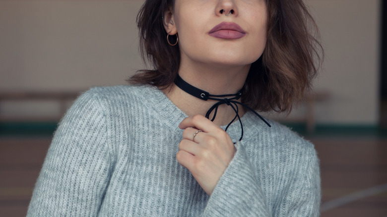 Woman wearing black collar necklace