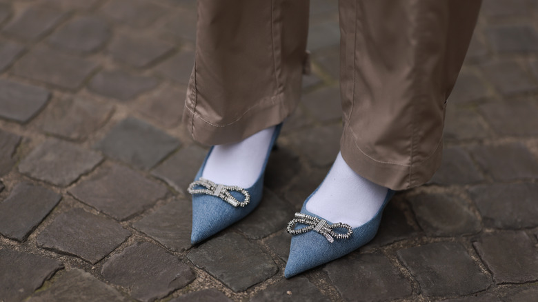 person wearing blue pointed toe shoes