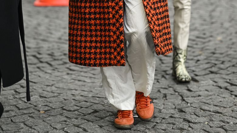 person wearing orange sneakers