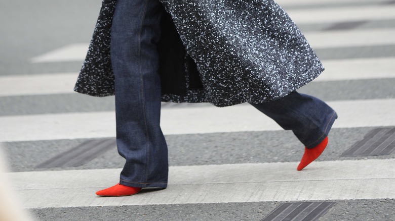 person wearing red pointed shoes