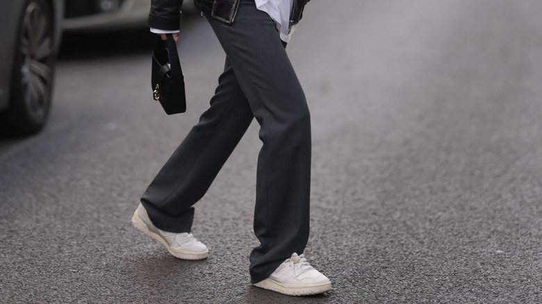 Person wearing white sneakers