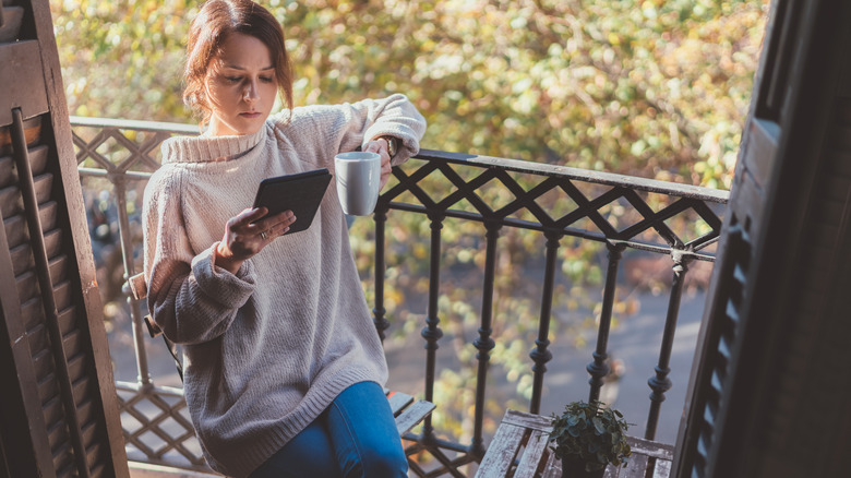 woman reading e-book on kindle