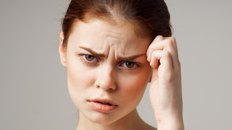 woman furrowing eyebrows