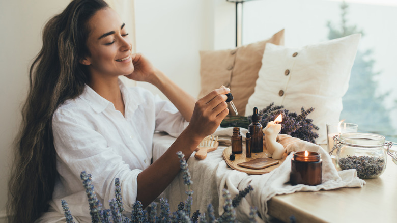 Woman applying beauty oil