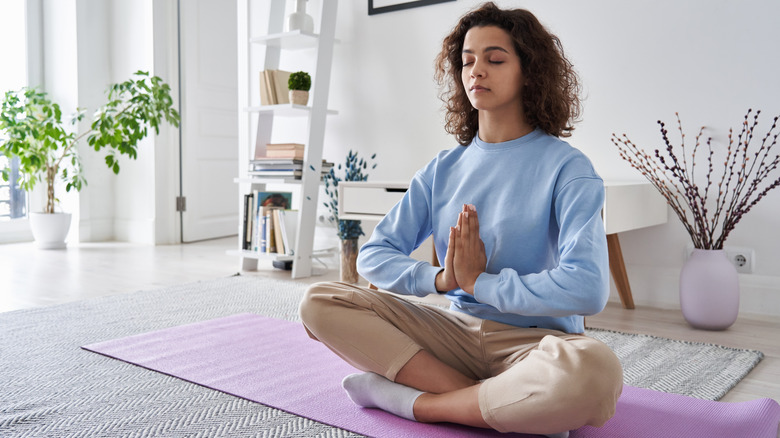 woman meditating in home