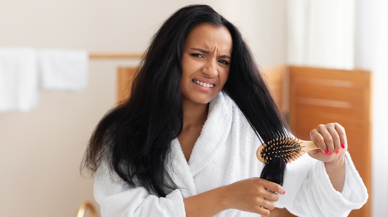 Woman having trouble detangling hair