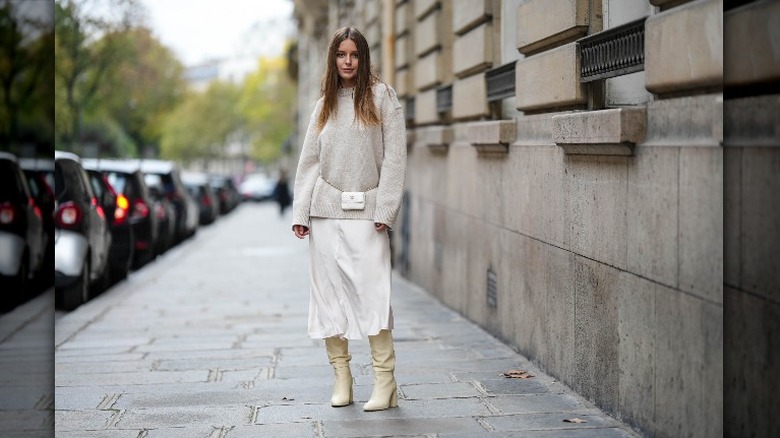 woman wearing sweater and skirt