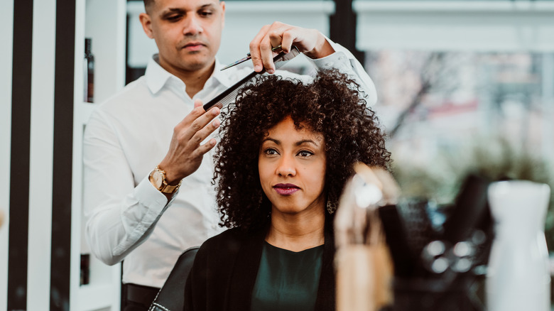 woman getting hair cut