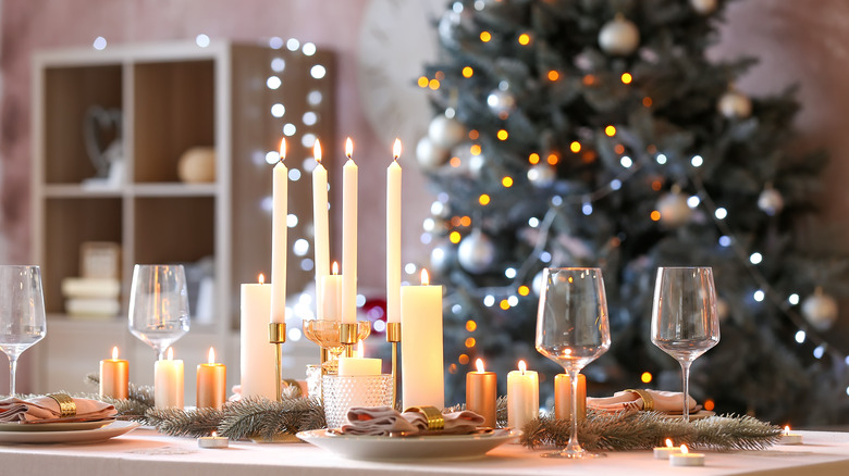 Christmas table setting with white taper and pillar candles