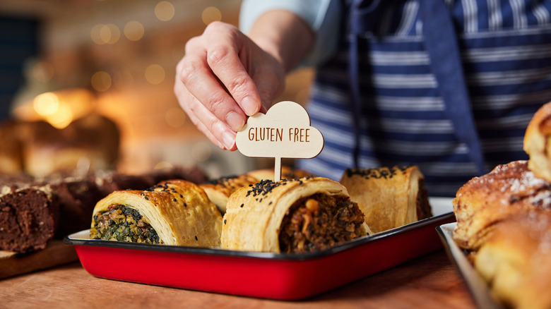 Baker placing 'gluten free' label atop savory stuffed roll