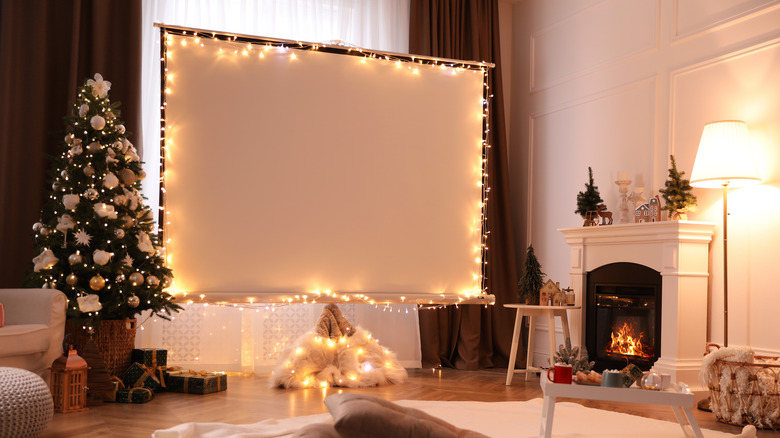 Festively decorated room featuring large projector screen