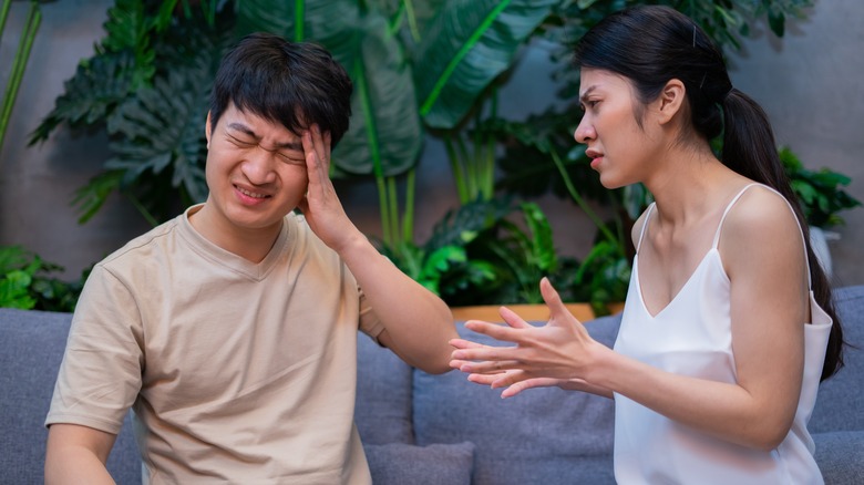 couple arguing on couch