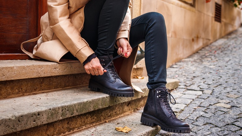 woman lacing up fall boots