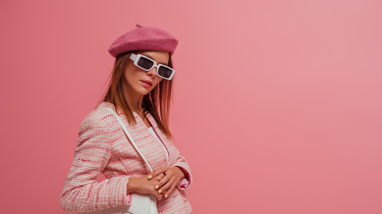 woman wearing pink beret and pink blazer