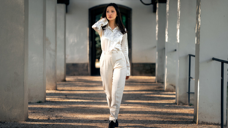 woman walking in white outfit