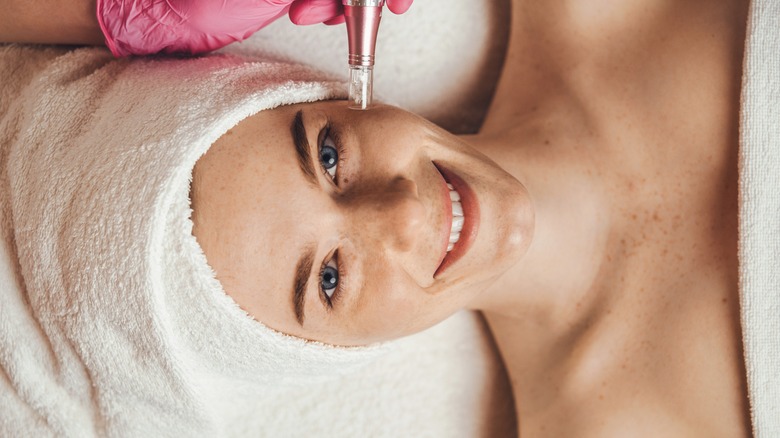 smiling woman getting microdermabrasion