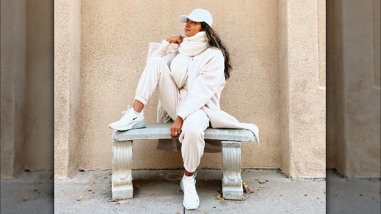 Girl wearing white sweatsuit.