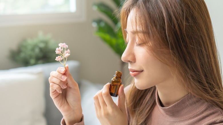 woman holding essential oil scent