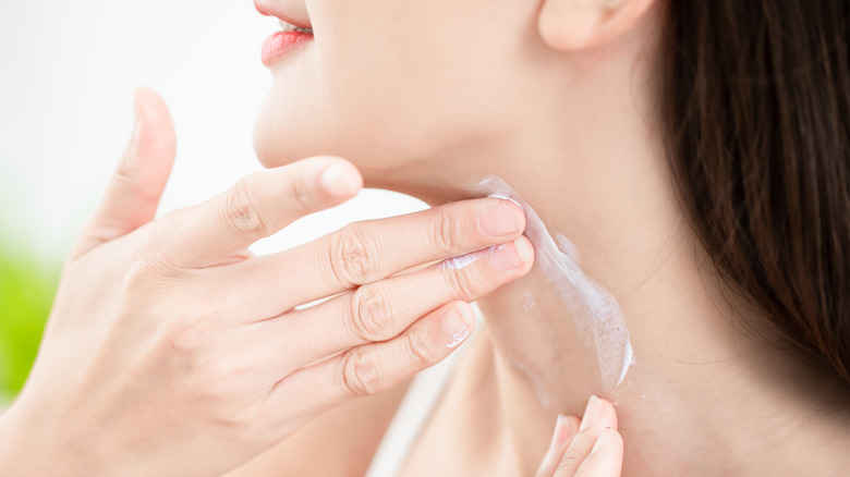 woman applying neck cream