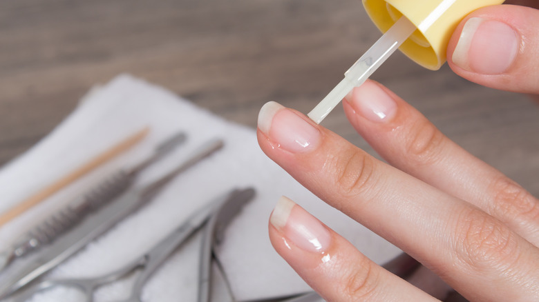 woman applying cuticile oil