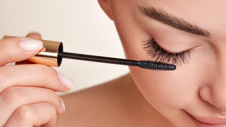 woman brushing lashes