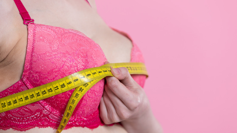 Woman measuring pink bra