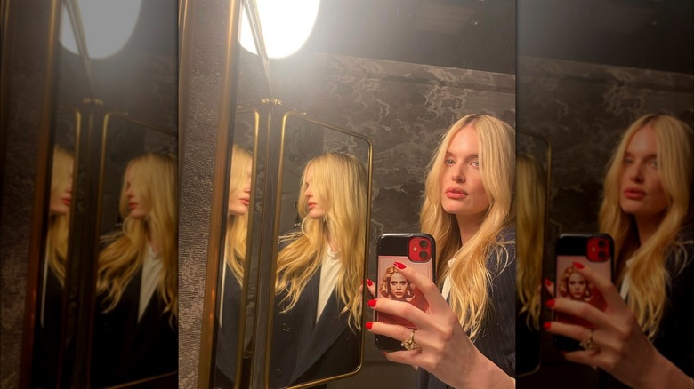 Woman with warm blond hair taking selfie