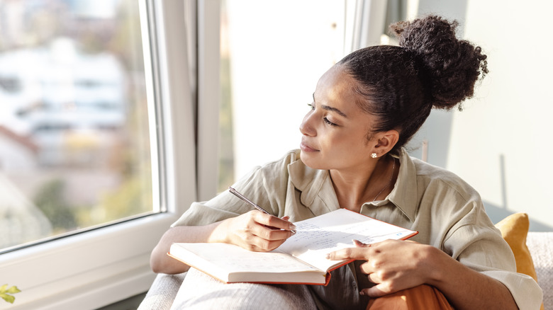 woman writing in journal